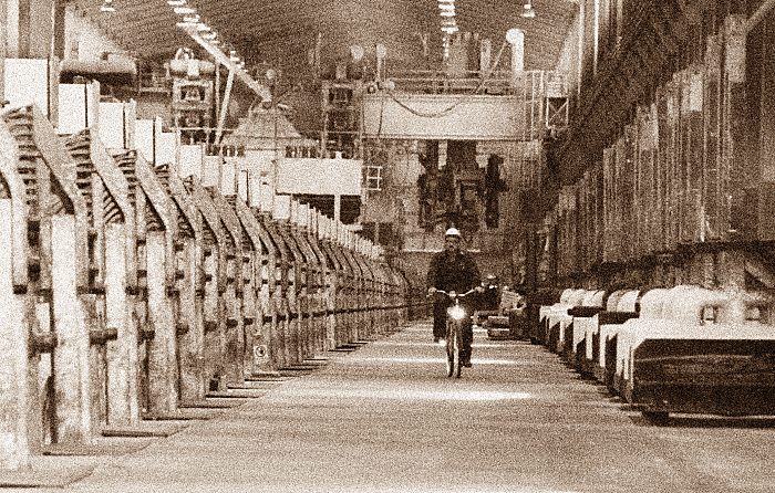 011_15608 - ein Mitarbeiter der Aluminiumhtte fhrt mit dem Fahrrad entlang der Elektrolysezellen in der Werkhalle der Finkenwerder Htte.