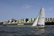 11_21420 Der Containerriese HATSU COURAGE hat Hamburg - Blankenese passiert und fhrt auf der Elbe Richtung Hamburger Hafen. Eine Segelyacht fhrt im Vordergrund hart am Wind. Das Containerschiff Hatsu Courage ist 334,00 m lang und 42,80m breit, es fhrt 25 Knoten / kn - der Frachter lief 2005 vom Stapel. Bei einem Tiefgang von 14,50 m und einer gross tonnage von 90449 (nett tonnage von 55452) kann er 8073 Standartcontainern / TEU Ladung an Bord nehmen.  www.bildarchiv-hamburg.de