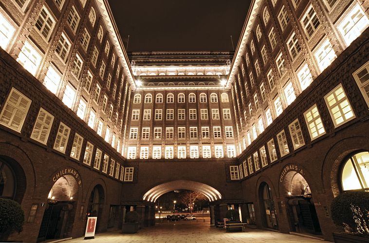 Architekturfotografie von Hamburger Sehenswrdigkeiten - Chilehaus bei Nacht  33_47932 Das Kontorhausviertel ist eine der vielen Sehenswrdigkeiten Hamburgs, das Touristen besucht haben sollten. Das Kontorgebude Chilehaus wurde von 1922 - 1924 im Hamburger Backsteinexpressionismus in der Hamburger Innenstadt errichtet; der Architekt war  Fritz Hger. Nachtaufnahme vom Innenhof des Chilehauses, der das 10stckige Gebude in das Chilehaus A + B unterteilt. Nach der ehemaligen Strasse, die sich dort befand wird dieser Durchgang Fischertwiete genannt, die zur Wandrahmsbrcke fhrte. www.hamburg-bilder.org