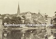 11_21572 historische Foto aus Bergedorf ca. 1890 - Blick ber den Hafen, alte Huser stehen am Wasser, einige Boote liegen am Ufer. In der Bildmitte der Kirchturm der Bergedorfer St. Petris und Pauli Kirche. Rechts die Rckseite der Kornwassermhle mit dem Giebeldach und der Winde. Der Ursprung des historischen Fachwerk- gebudes wurde um 1208 dort an der aufgestauten Bille errichtet. 1839 erfolgte ein Neubau, 1868 folgte eine Erweiterung.  www.hamburger-fotoarchiv.de