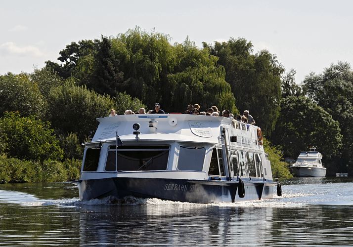 Bilder aus den Hamburger Bezirken - Bergedorfer Dove - Elbe, Ausflugsschiff  11_21600 Eine Ausflugsbarkasse fhrt mit Bergedorf-Touristen an Bord auf seiner Rundfahrt durch die Vier- und Marschlande auf der Doveelbe. Auf dem Fahrgastschiff SERRAHN STARr der Bergedorfer Schifffahrtslinie sitzen die Fahrgste auf dem Sonnendeck und geniessen den Ausblick bei Hamburger Sommerwetter. Im Hintergrund eine Motoryacht die am Bootssteg liegt. www.hamburg-fotos.org