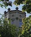 11_21520 Zwischen den Bumen ragt im Bergedorfer Villen- viertel ein Turm mitangedeuteten Zinnen empor. Ende des 19.  Jahrhunderts wurde begonnen, das sogenannte Villenviertel zu bebauen - wohlhabende Hamburger und Bergedorfer Brger lieen dort ihre reprsentativen Wohnhuser errichten. Es entstanden Stadthuser, die die unterschiedlichen Stile der Architektur ausdrckten - neben der Bauform der Grnderzeit wurde auch der Jugendstil architektonisch umgesetzt oder Wohnhuser in der Architektur der neuen Sachlichkeit gebaut.  www.hamburg-fotograf.com