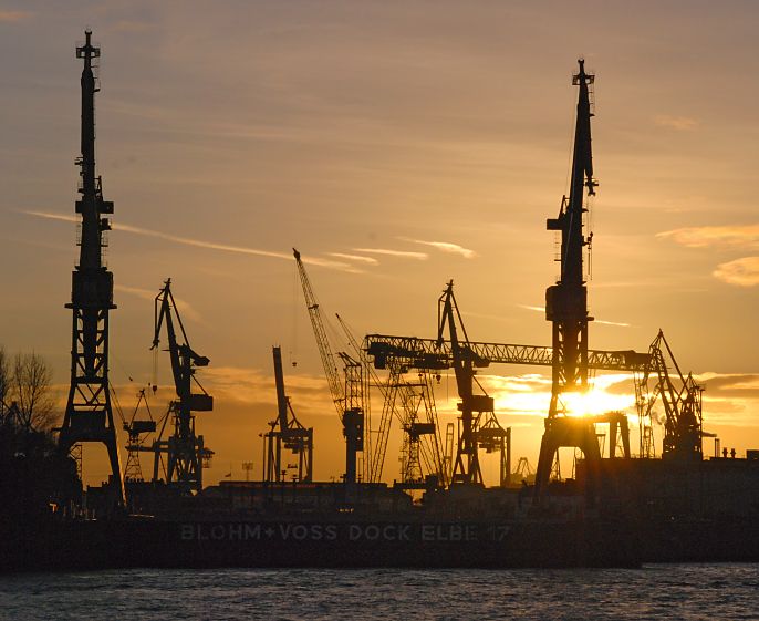 Sonnenuntergang im Hafen Hamburg - Krne als Silhouette / im Gegenlicht.  07_26041 Im Hamburger Hafen geht die Sonnen unter. Die Silhouetten der Hafenkrne er Werft Blohm + Voss zeichnen sich im roten Abendhimmel ab. www.fotograf-hamburg.de