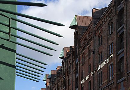 011_17388 - zugespitzte Eisen verhindern ein bersteigen des Zauns; Giebel der Speicherstadt mit dem goldenen Schriftzug "Hamburg Port Authority" an der Hausfassade. Bild Hamburg