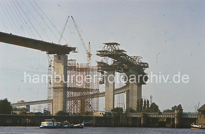 Hamburgbilder - Fotos der Brcken und Strassen. Konstruktion der Khlbrandbrcke (ca. 1972).  08_15579 Die Khlbrandbrcke wurde 1974 eingeweiht und berquert den 325m breiten Khlbrand. Der Brckenzug ist insgesamt 3618m lang und die zweitlngste Straenbrcke Deutschlands. Das Bauwerk besteht aus der stlichen Rampenbrcke, der Strombrcke und der westlichen Rampenbrcke. Die stliche Rampenbrcke ist eine 2050m lange Stahlbeton- und Spannbetonkonstruktion, die 520m lange Strombrcke ist als Schrgseilbrcke in Stahl ausgefhrt und die 1048m lange westlichen Rampenbrcke aus Spannbeton. Rechts die Rugenberger Schleuse - die Schleusentore ffnen sich gerade, zwei Schiffe wollen die Schlickschleuse zur Durchfahrt in den Waltershofer Hafen nutzen.