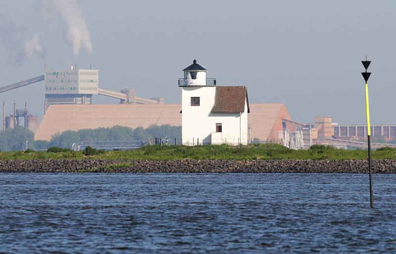 Bilder aus der Metropolregion Hamburg / Elbe bei Stade. Leuchtfeuer Julessand - Aluminium Oxyd Stade. 062_8012 Blick vorbei am historischen Leuchtfeuer Julessand zum gegenüber liegenden Elbufer zur Aluminium Oxyd Stade GmbH. Rechts steckt im Boden der flachen Elbe ein Seezeichen, das auf eine Gefahrenstelle / Untiefe hinweist; die Stellung der schwarzen Dreiecke weist darauf hin, das diese Gefahrenstelle südlich des Steckens umfahren werden muss.