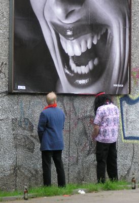 011_14221 - zwei Mnner pinkeln im Freien an eine Mauer, ihre Bierflaschen sorgfltig abgestellt  - eine lachende Frau hat Einblick.